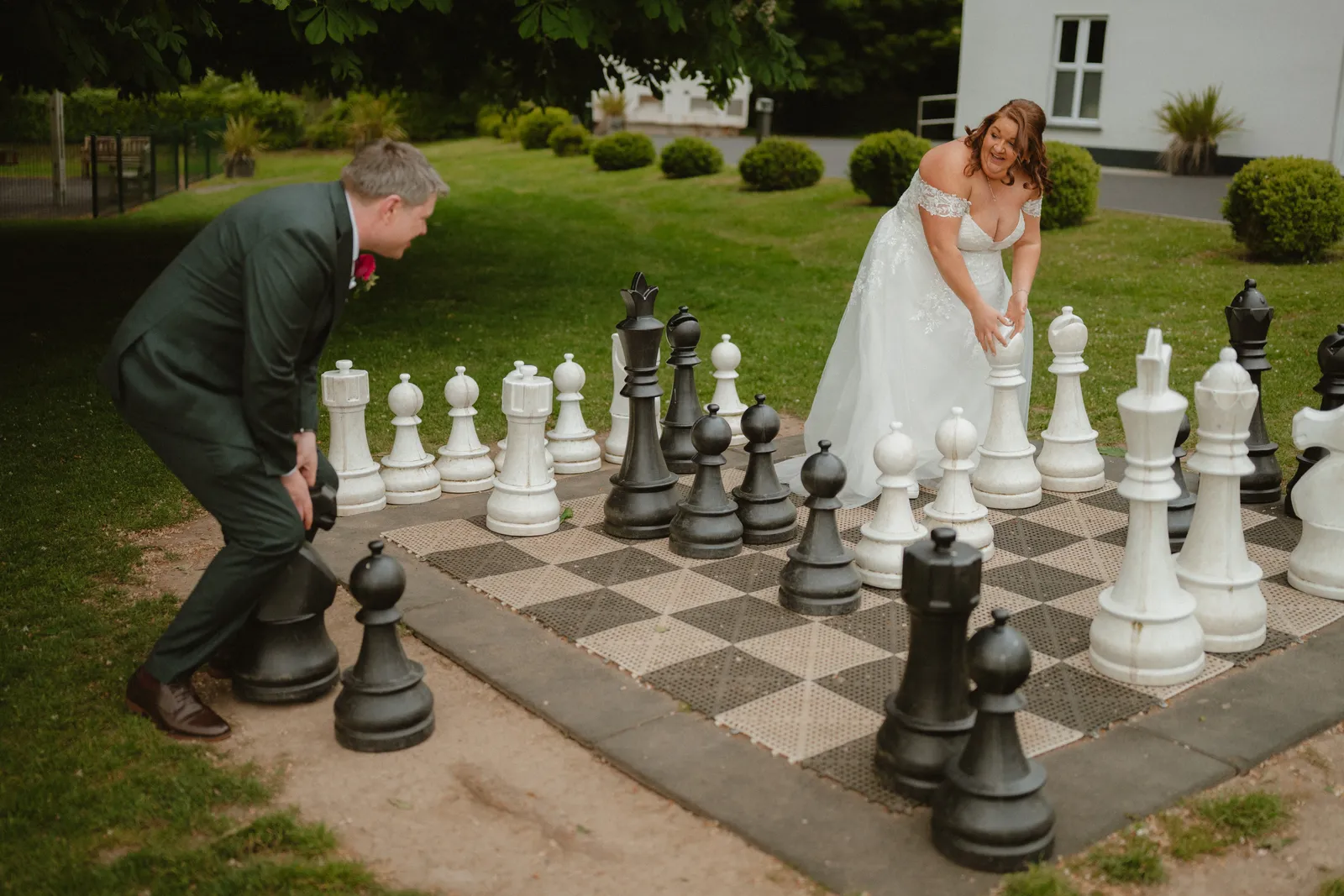 Michelle and Ray playing with the giant chess pieces