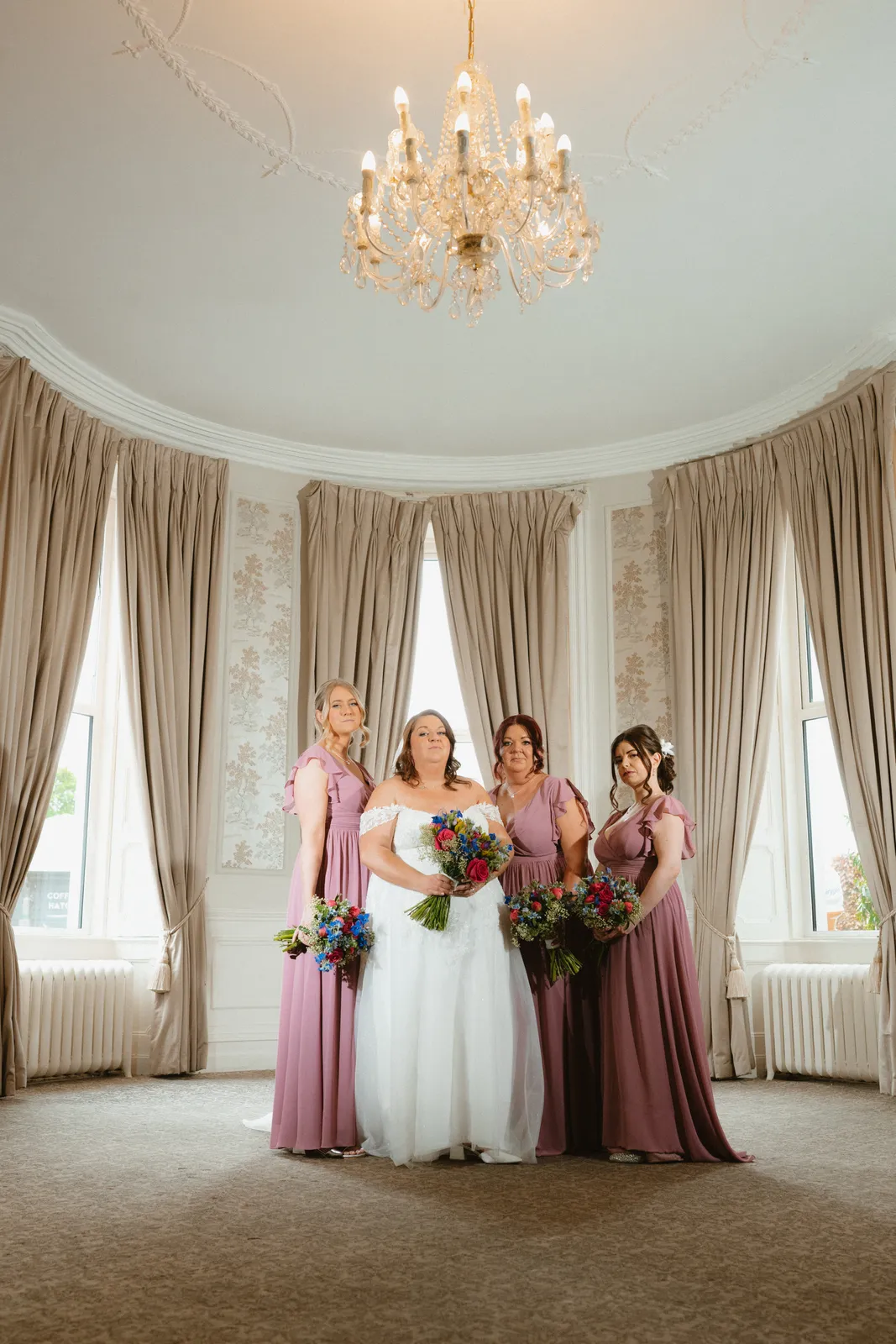 Michelle with women in mauve dresses beside the windows