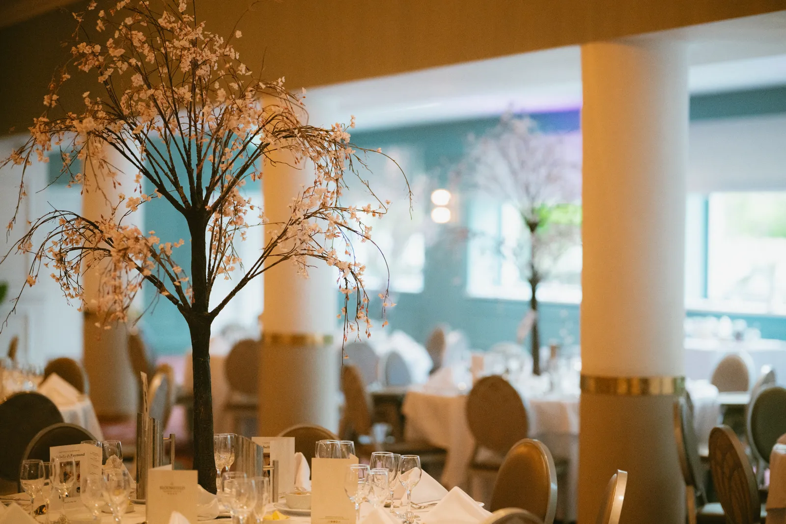 Reception tables set with tall centrepieces