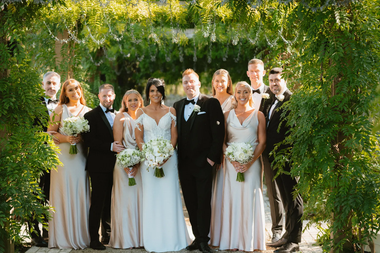 Wedding group beneath the greenery