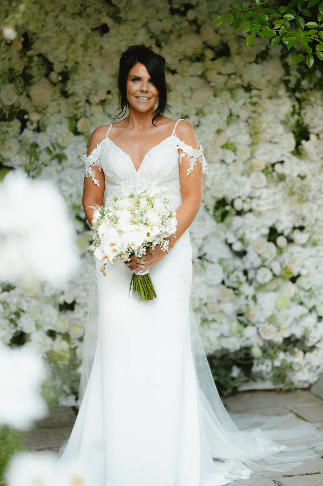 Nicola beneath a flower-covered arbour