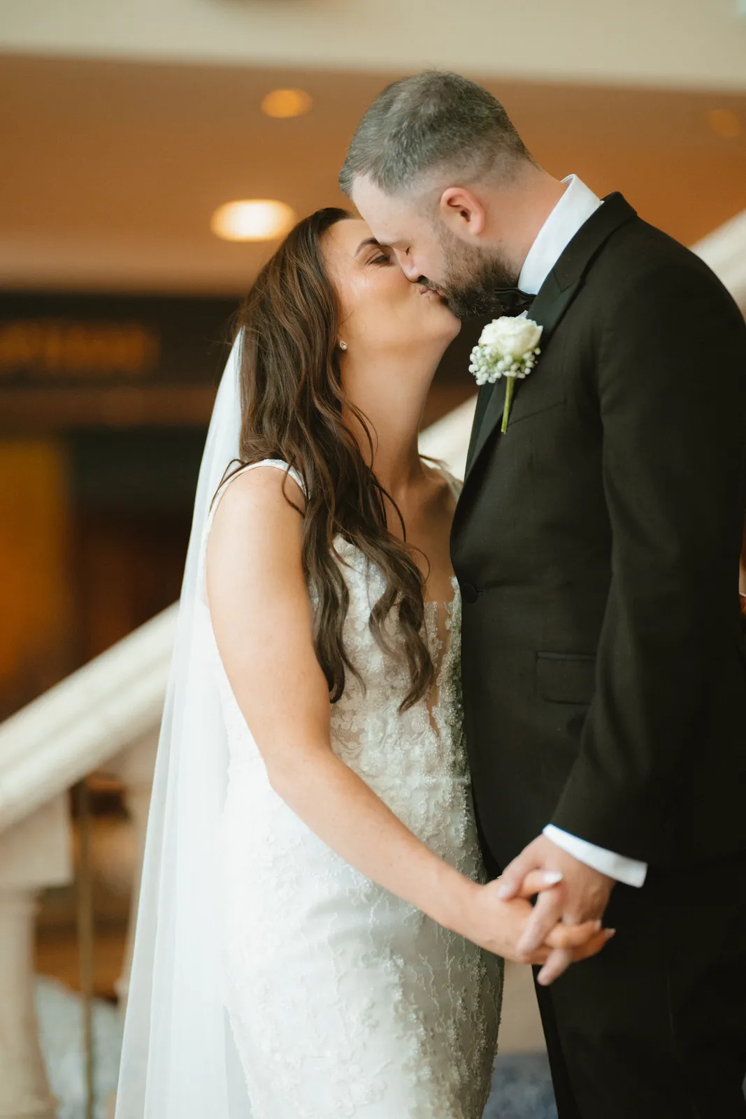 Nicola and Lee standing close in the hotel
