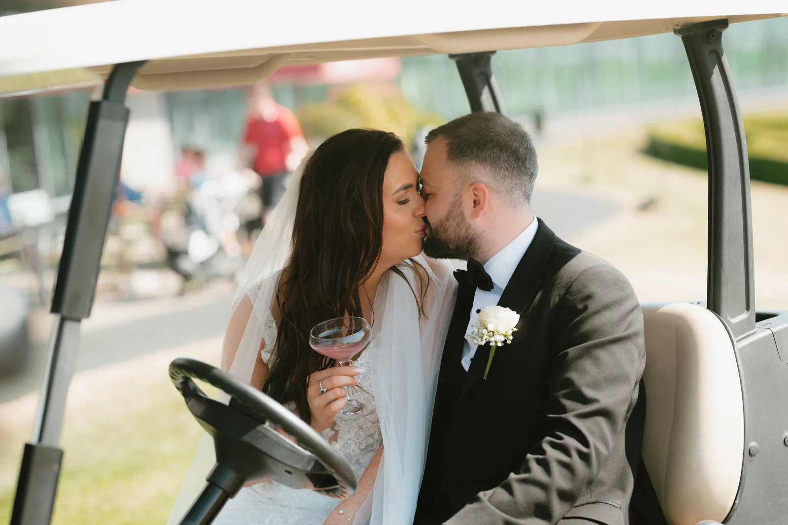 Nicola and Lee kissing in the golf buggy