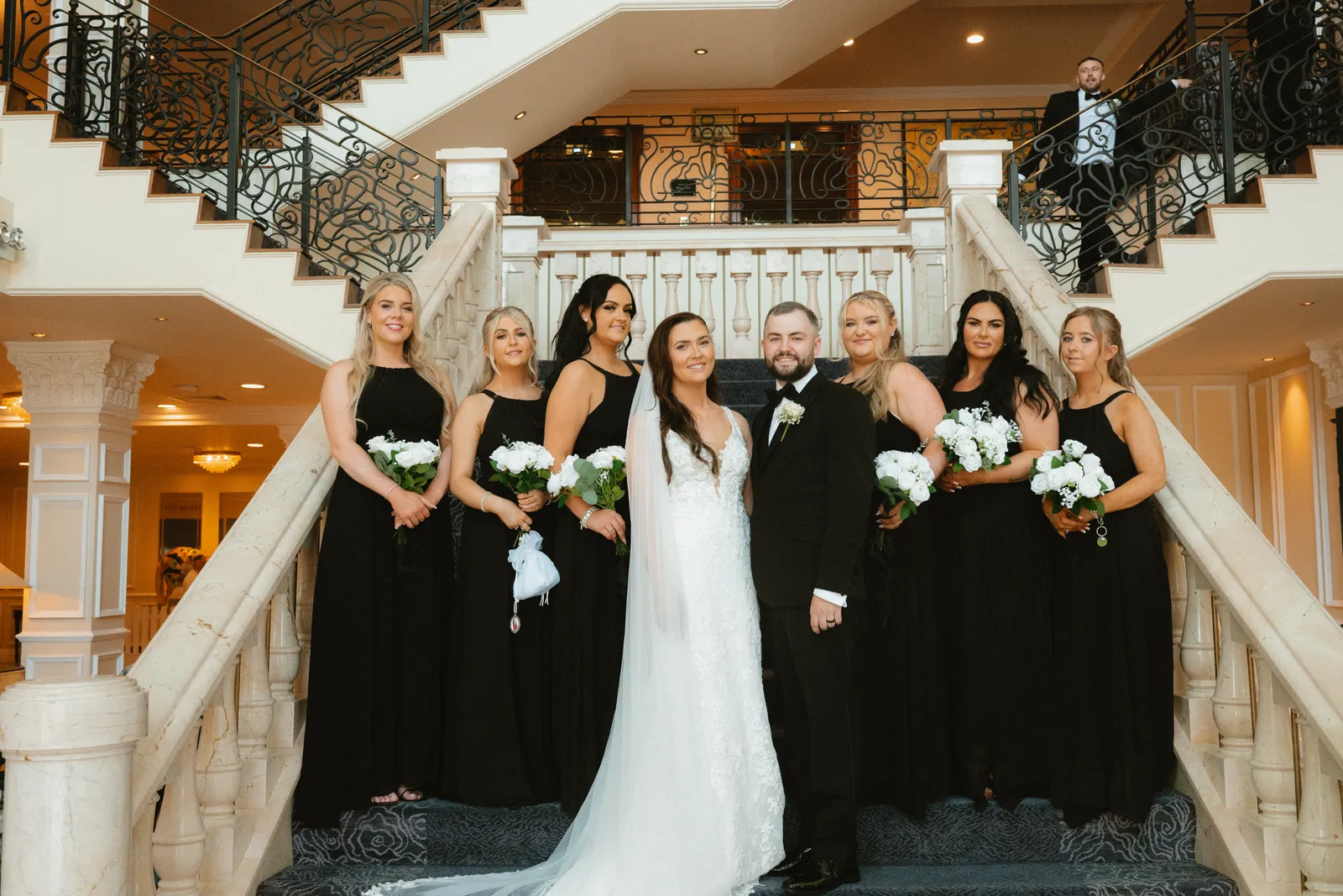 Nicola with women holding bouquets on the staircase