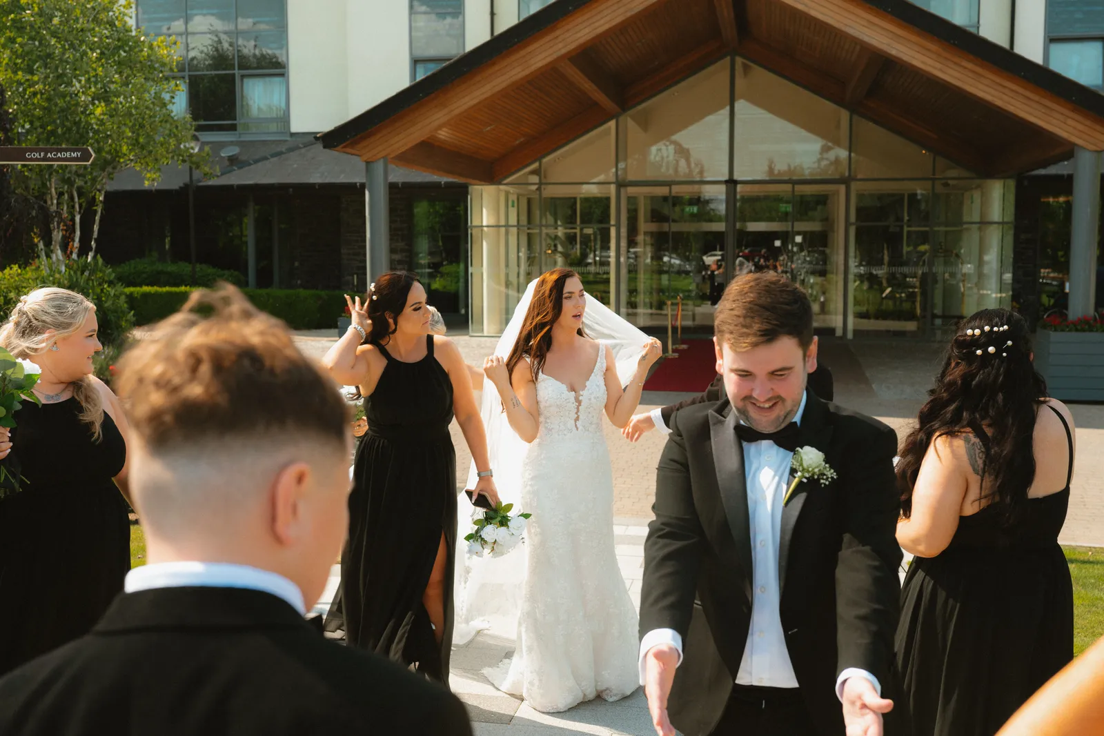 Guests celebrating outside the hotel entrance