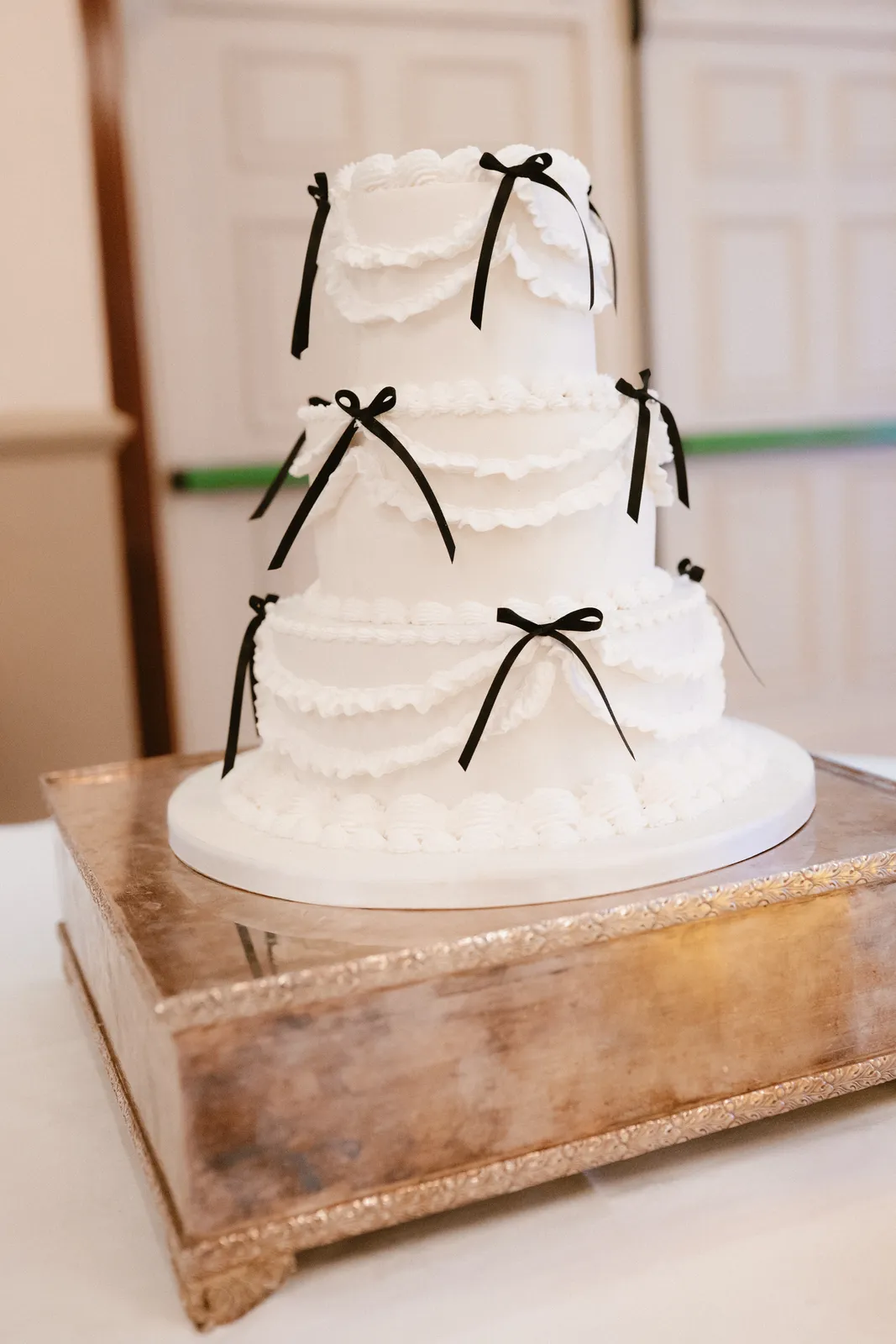 White wedding cake with black ribbons
