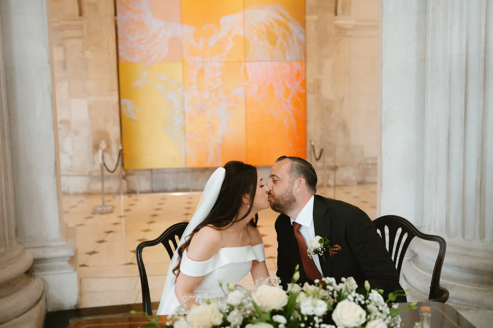The couple kiss at the table