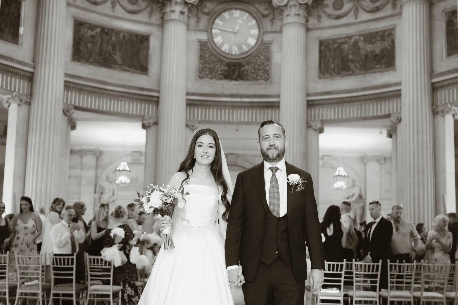 Rebecca and Curtis walk together through the rotunda at Dublin City Hall.