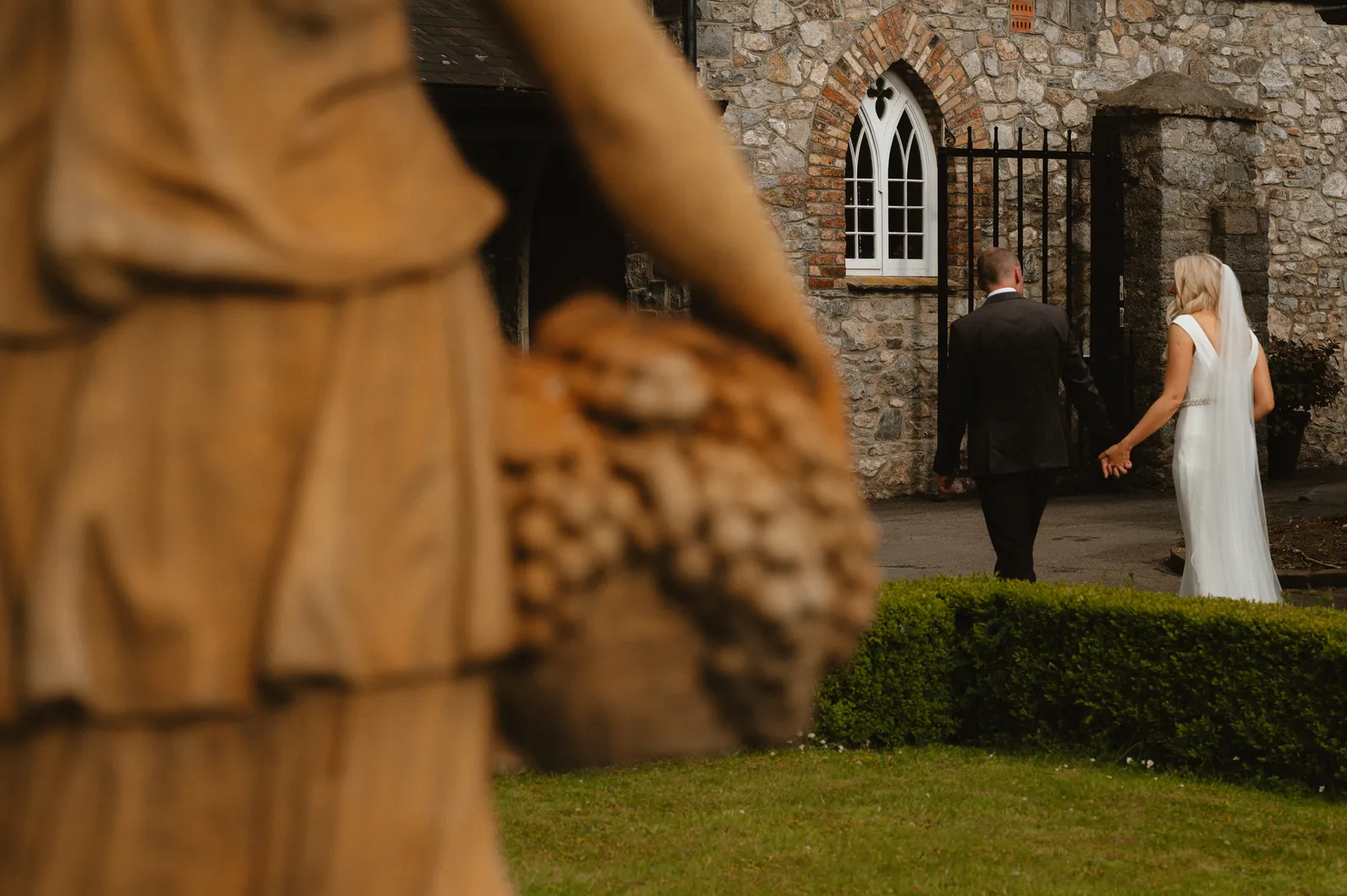 The couple seen past a guest in the garden