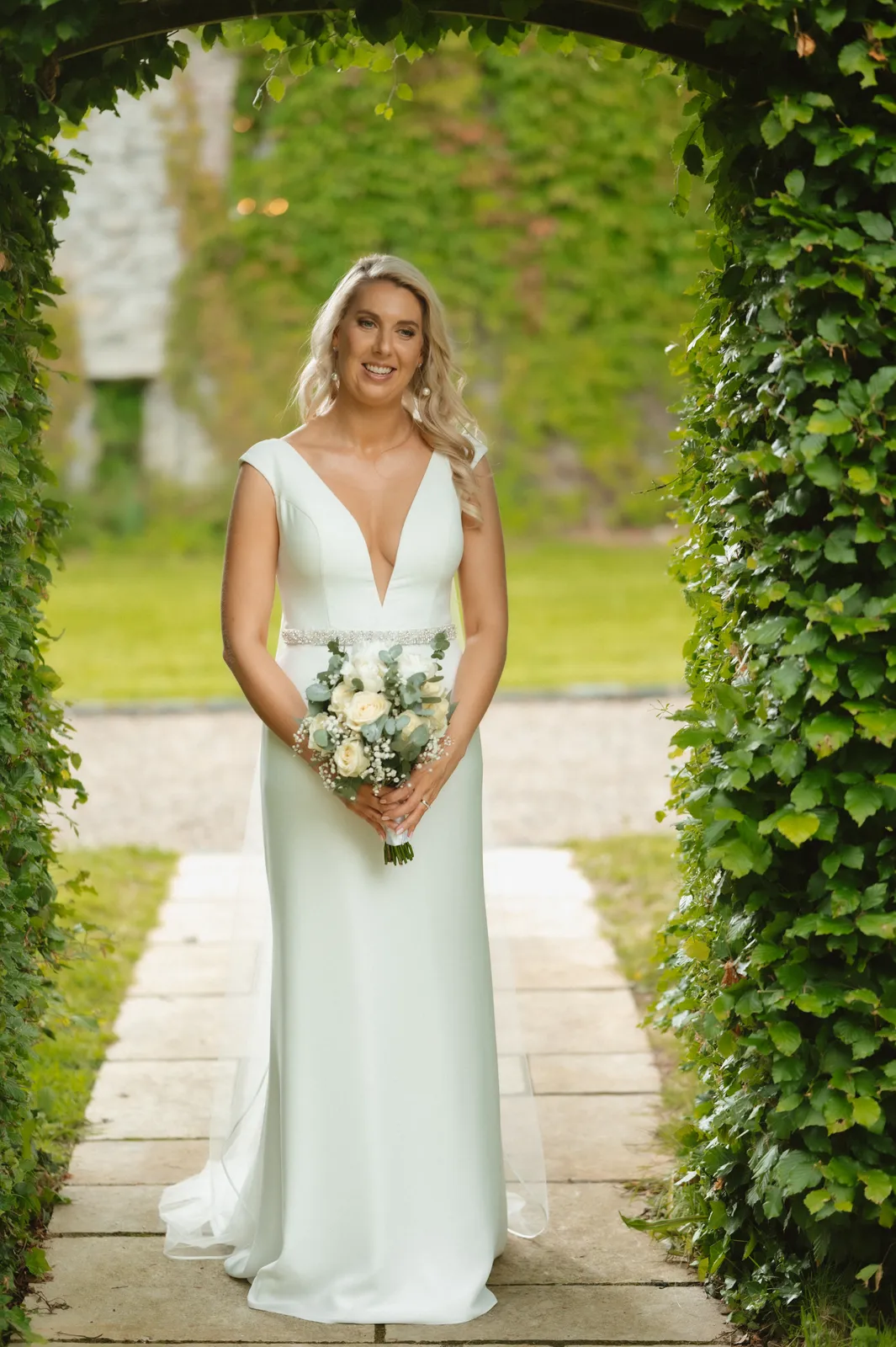 Rebecca beneath the clipped garden arch