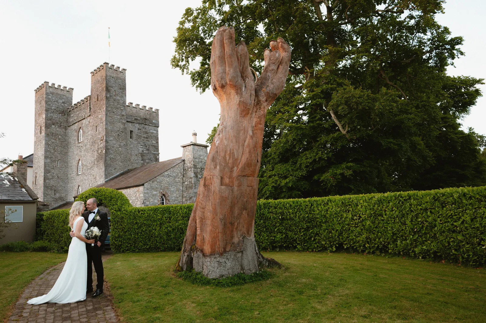 Rebecca and Patrick beneath a tall tree with Barberstown Castle behind them