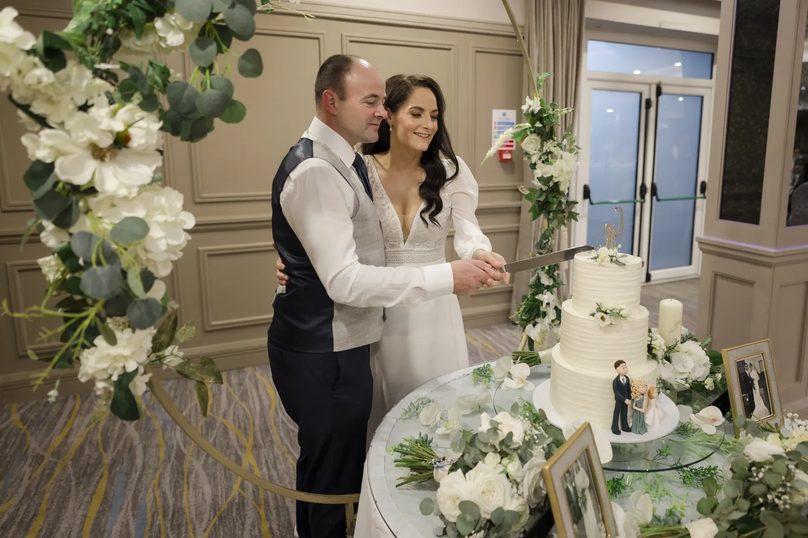 The couple beside the wedding cake