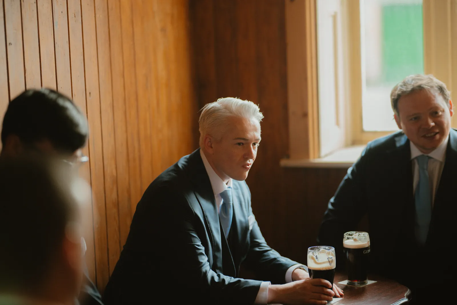 Jack and a guest seated with drinks