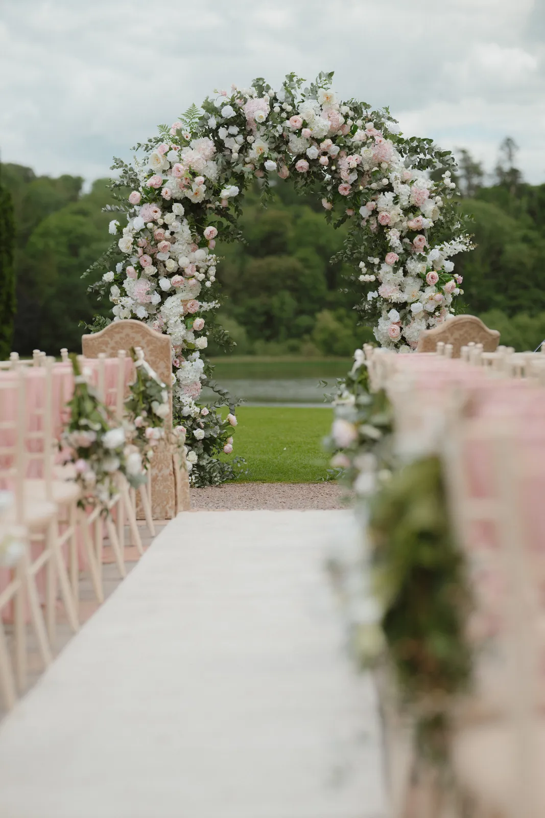 Flower arch and chairs set for the outdoor ceremony