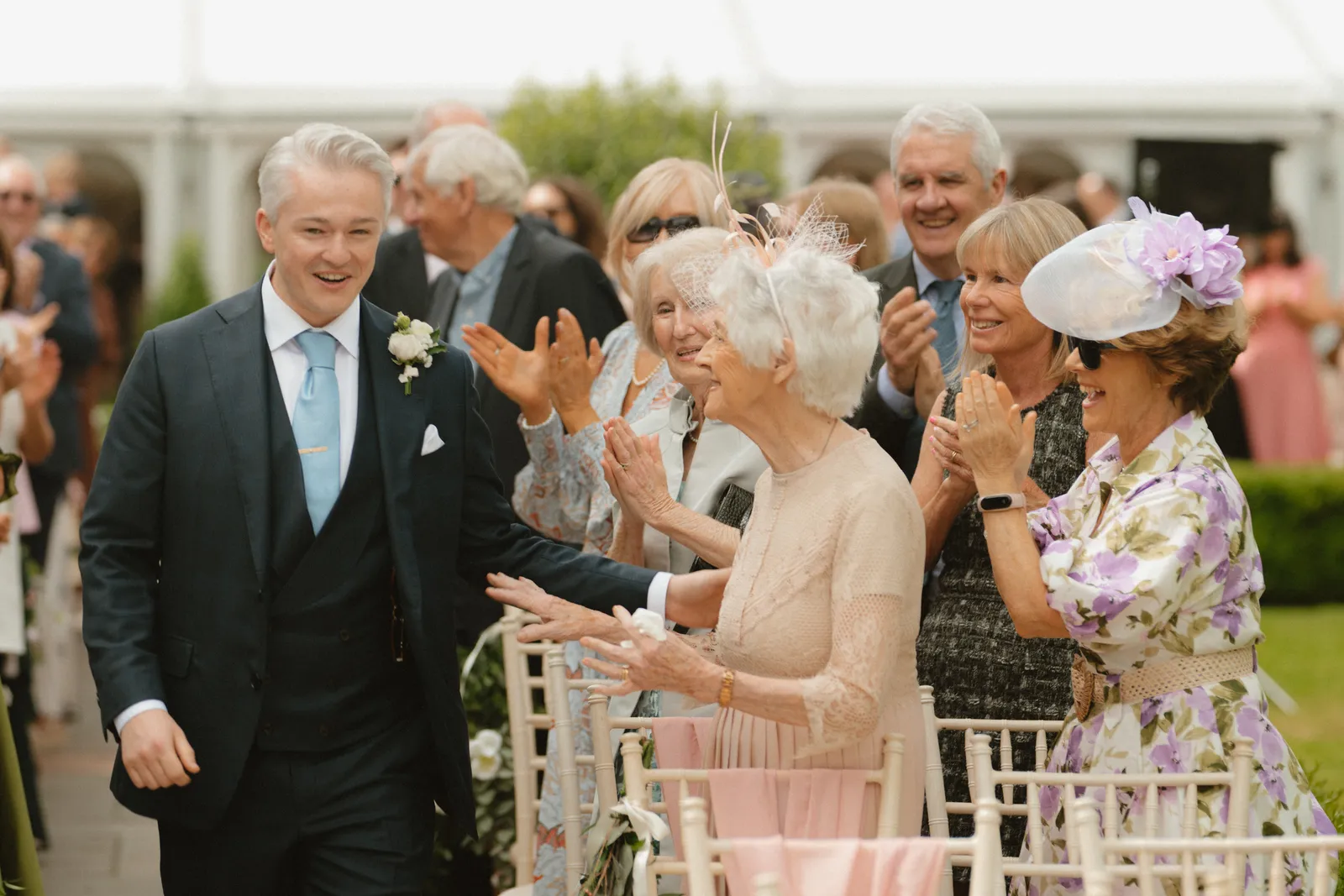 Guests gathering along the ceremony aisle