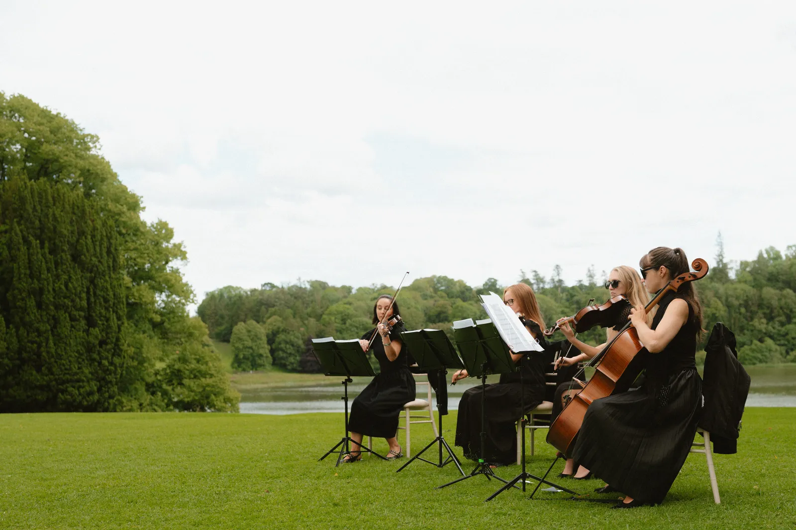 Musicians playing beside the lake