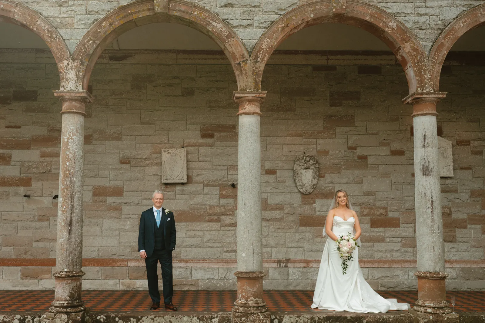 Roslyn and Jack beneath the stone arches
