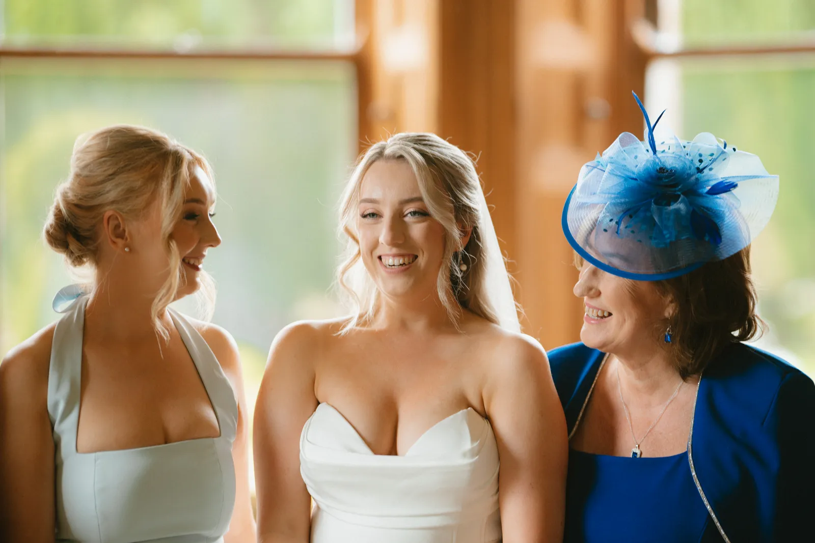 Roslyn laughing with guests beside the windows