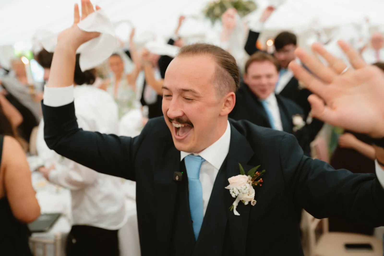 A guest celebrating with a raised napkin