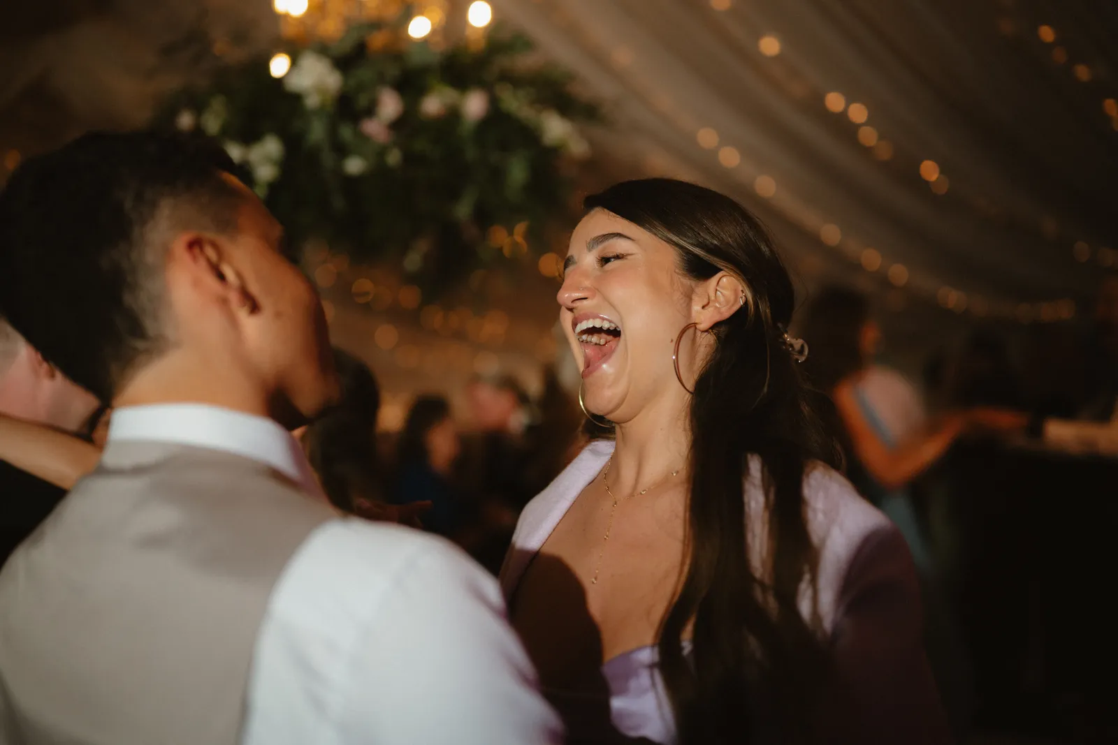 A guest laughing on the dance floor