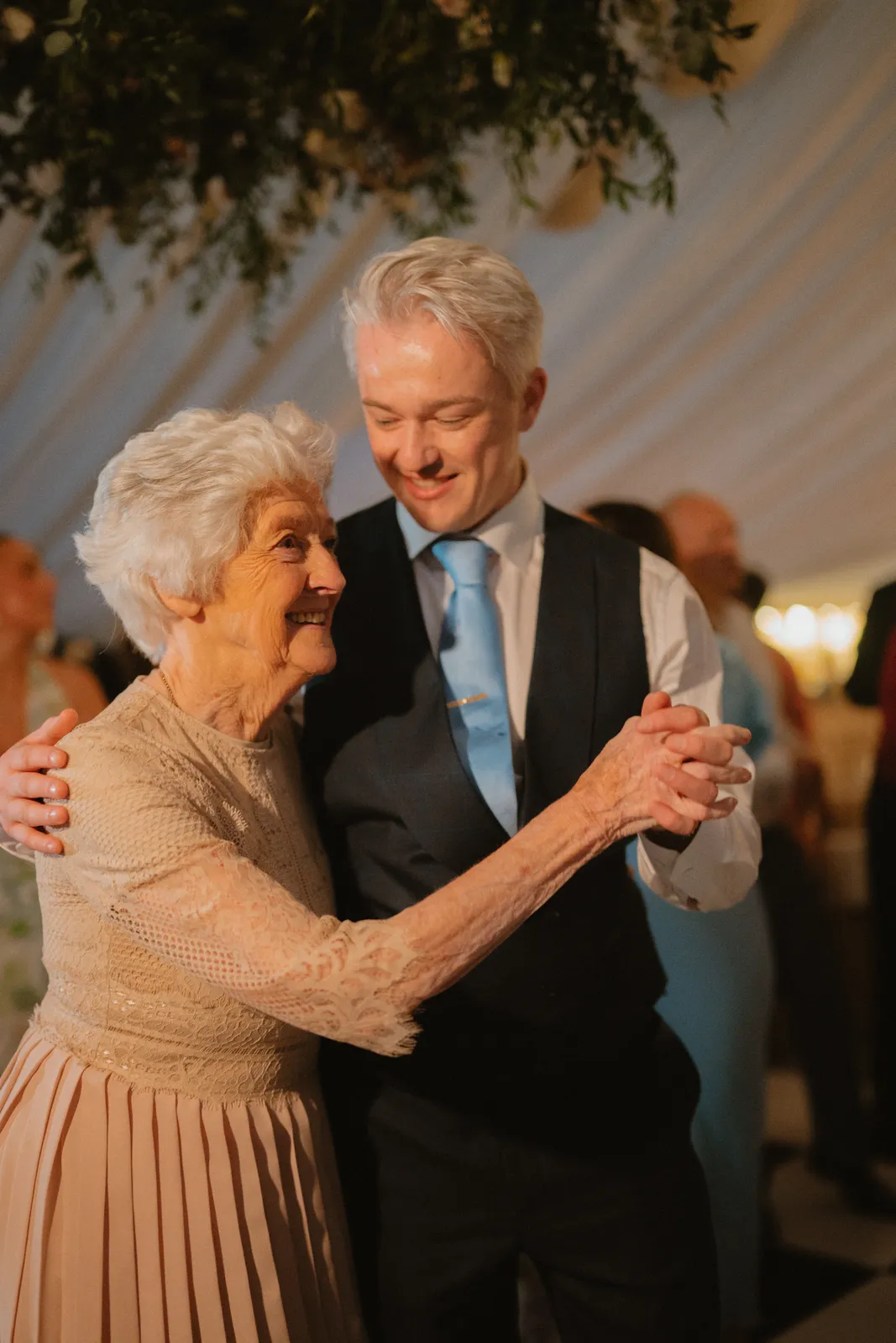 Guests smiling together beneath the lights