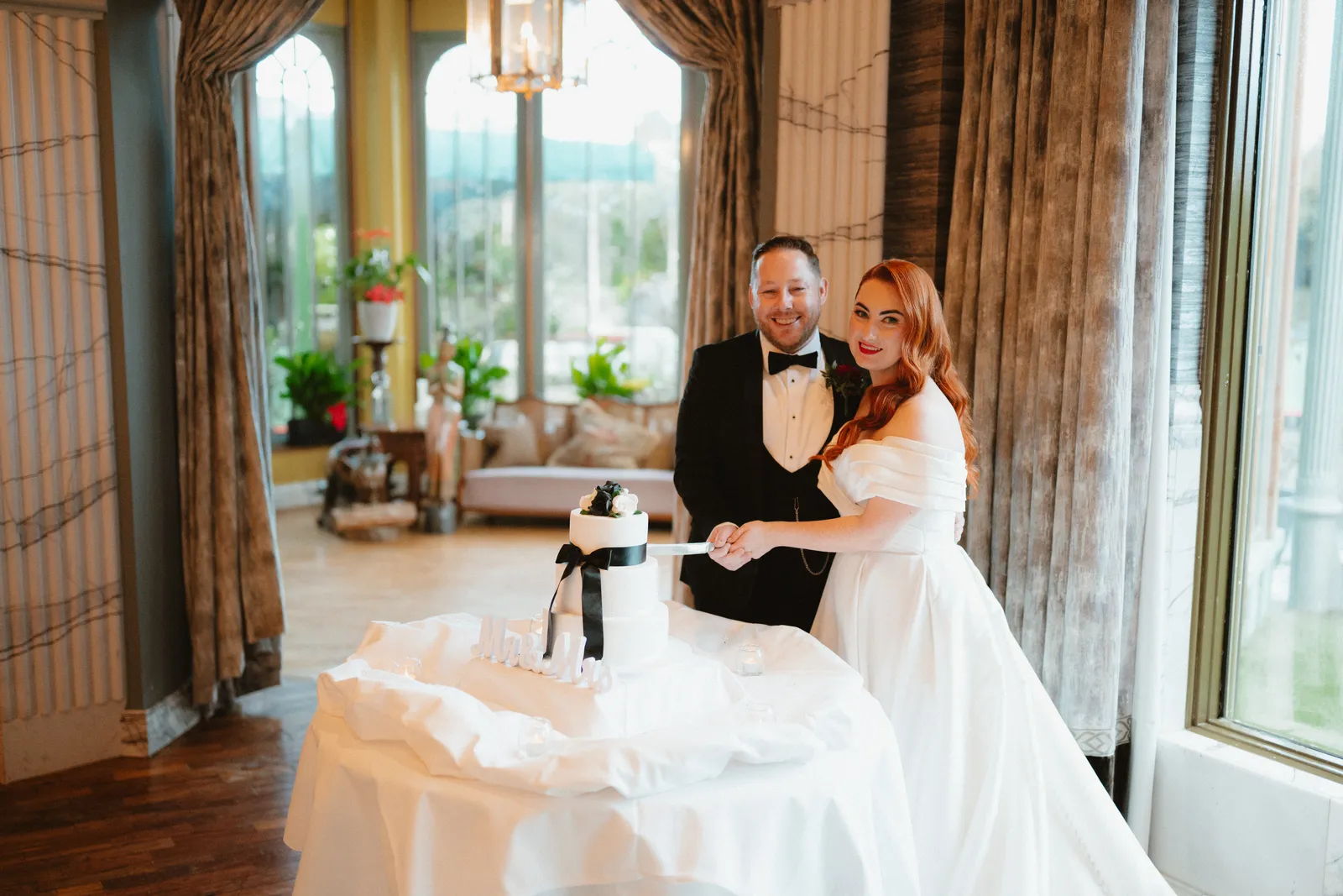 Sarah and Mark beside the conservatory windows
