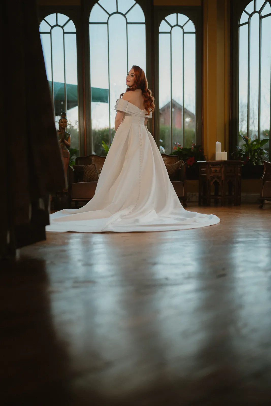 Sarah framed by tall arched windows