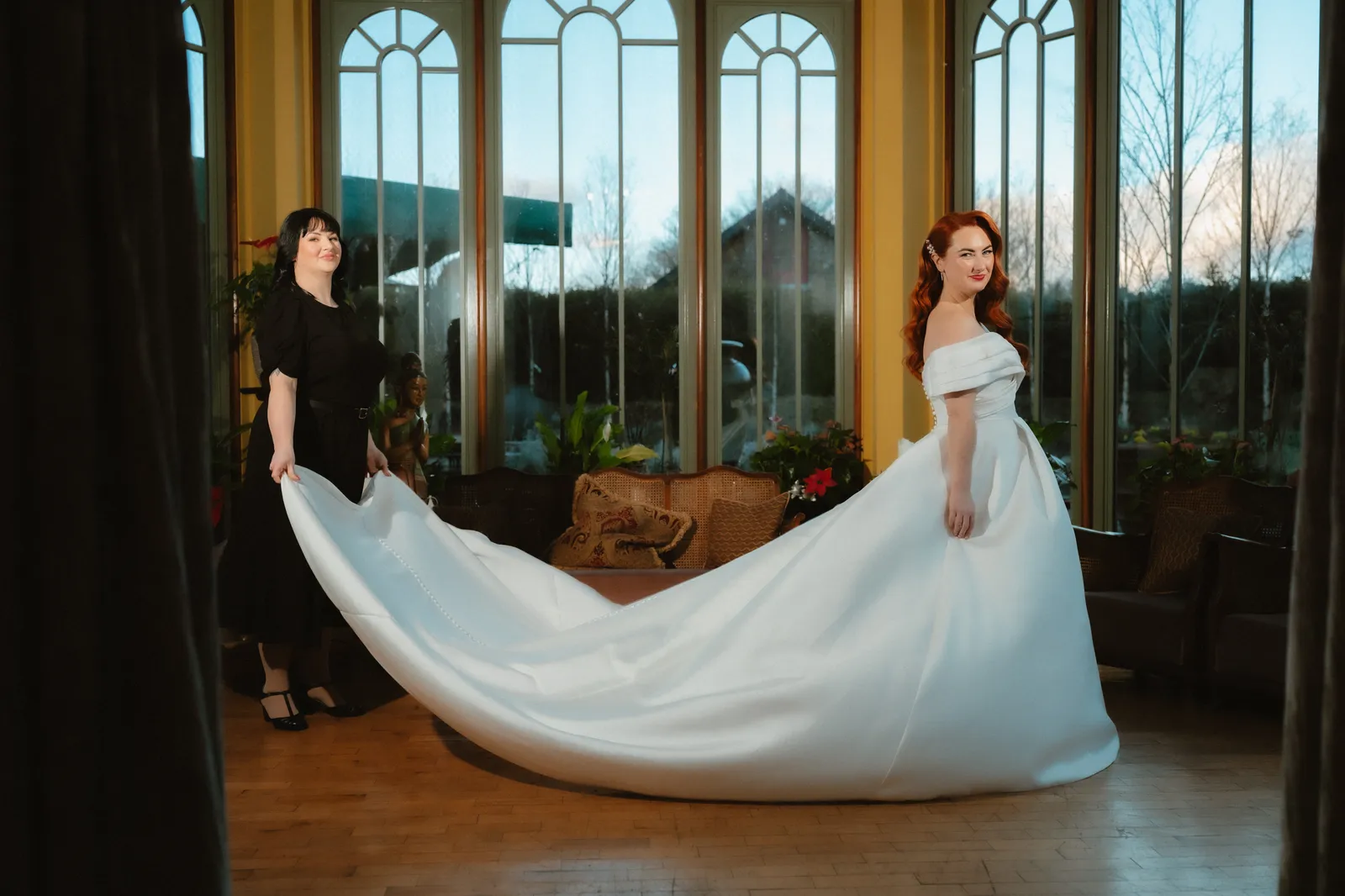 Sarah’s dress spread out beside the windows