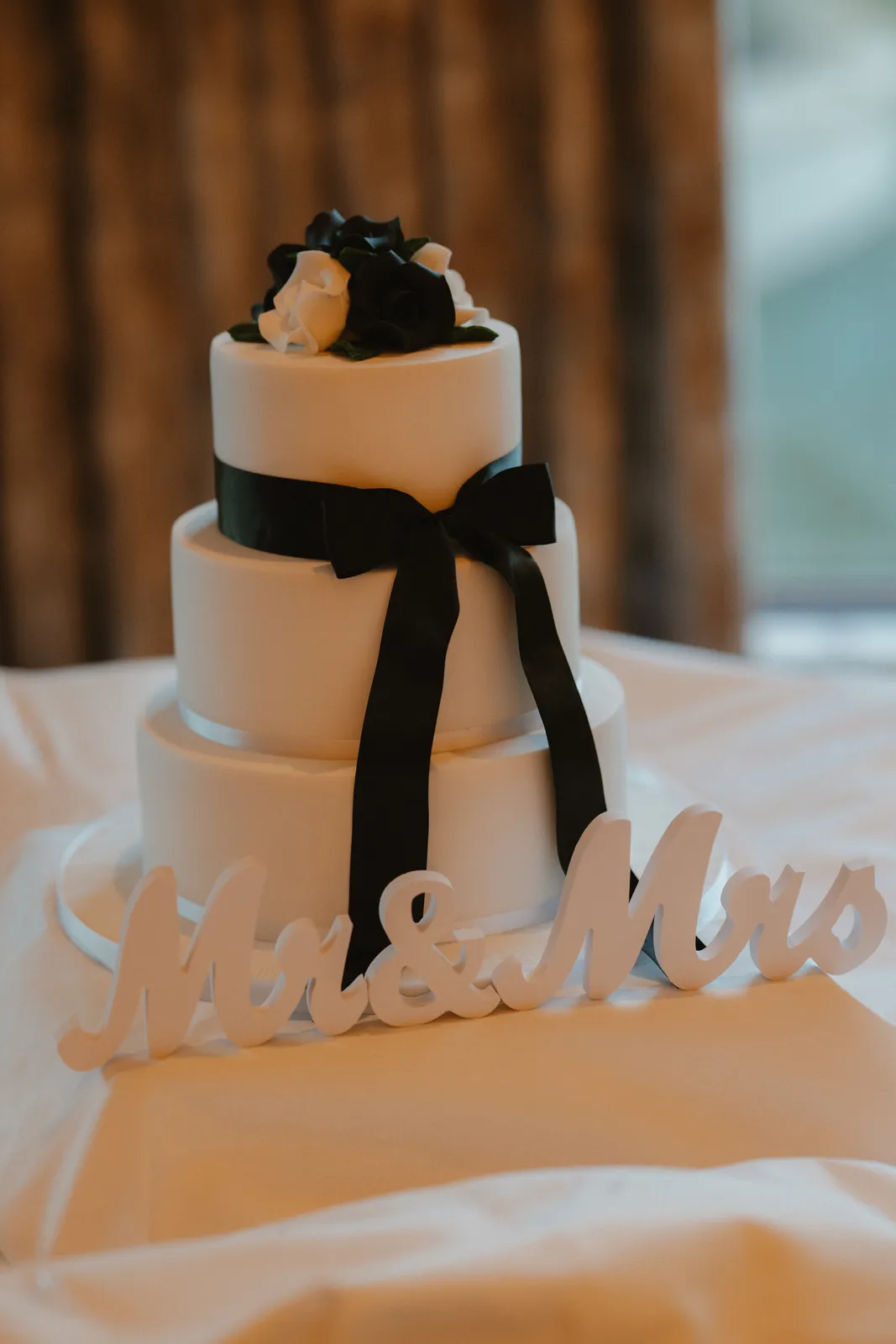 Wedding cake decorated with a black ribbon