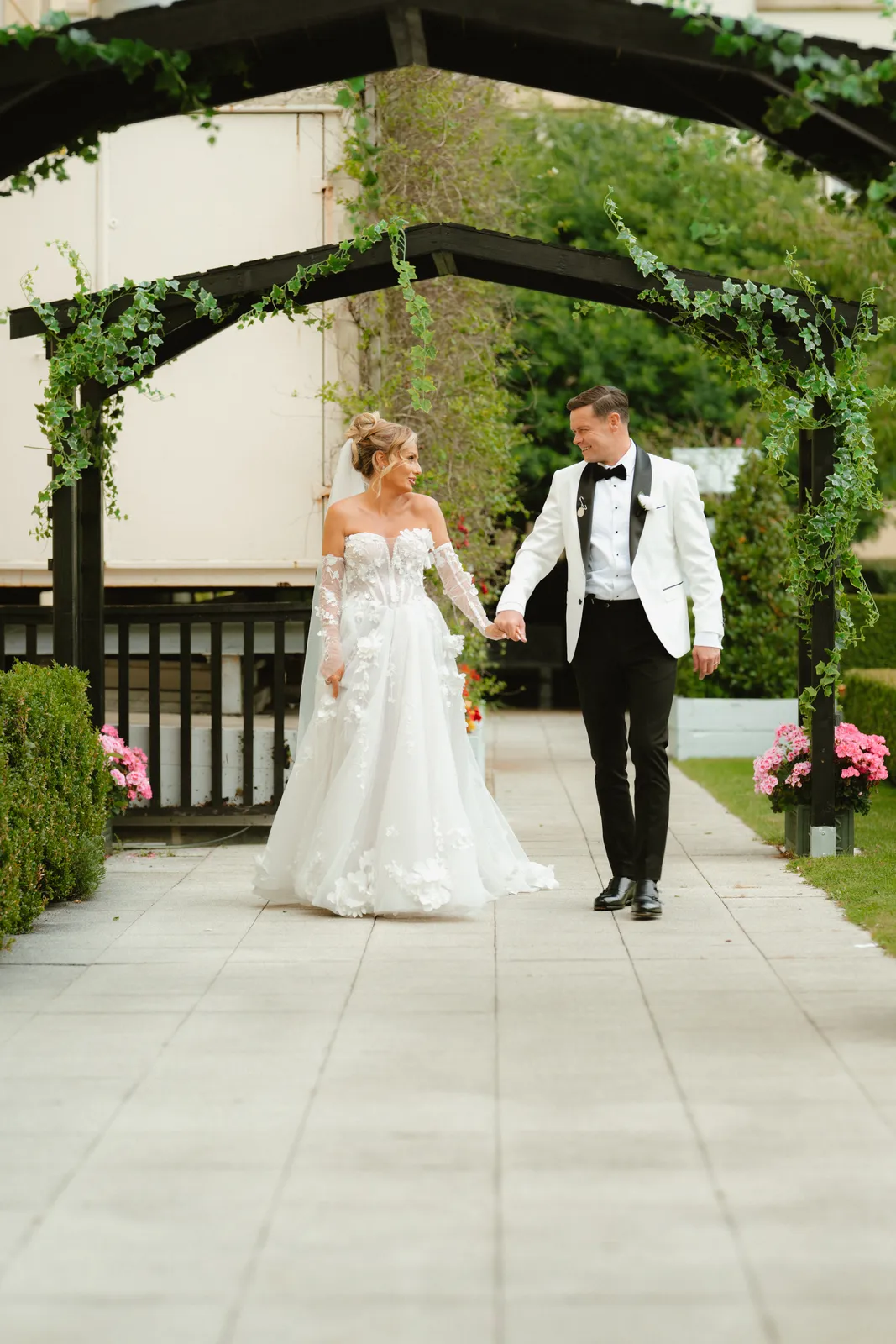 The couple walk through an archway