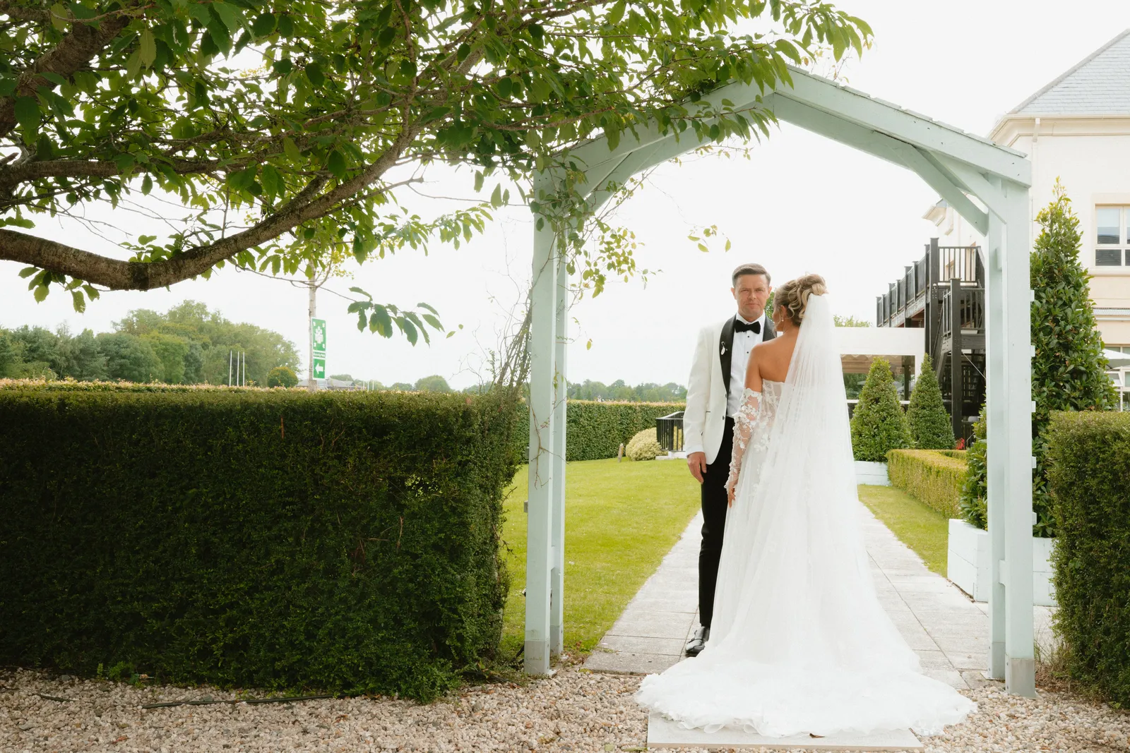 The couple beneath a garden arch