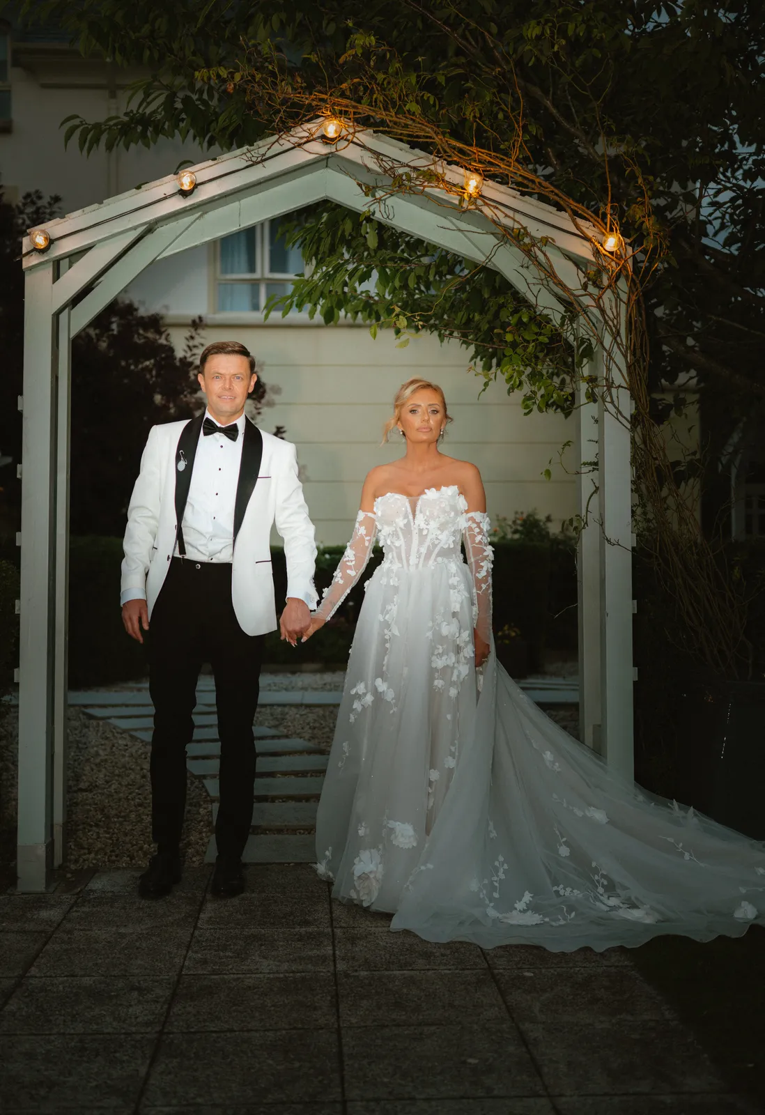 The couple outdoors after dark