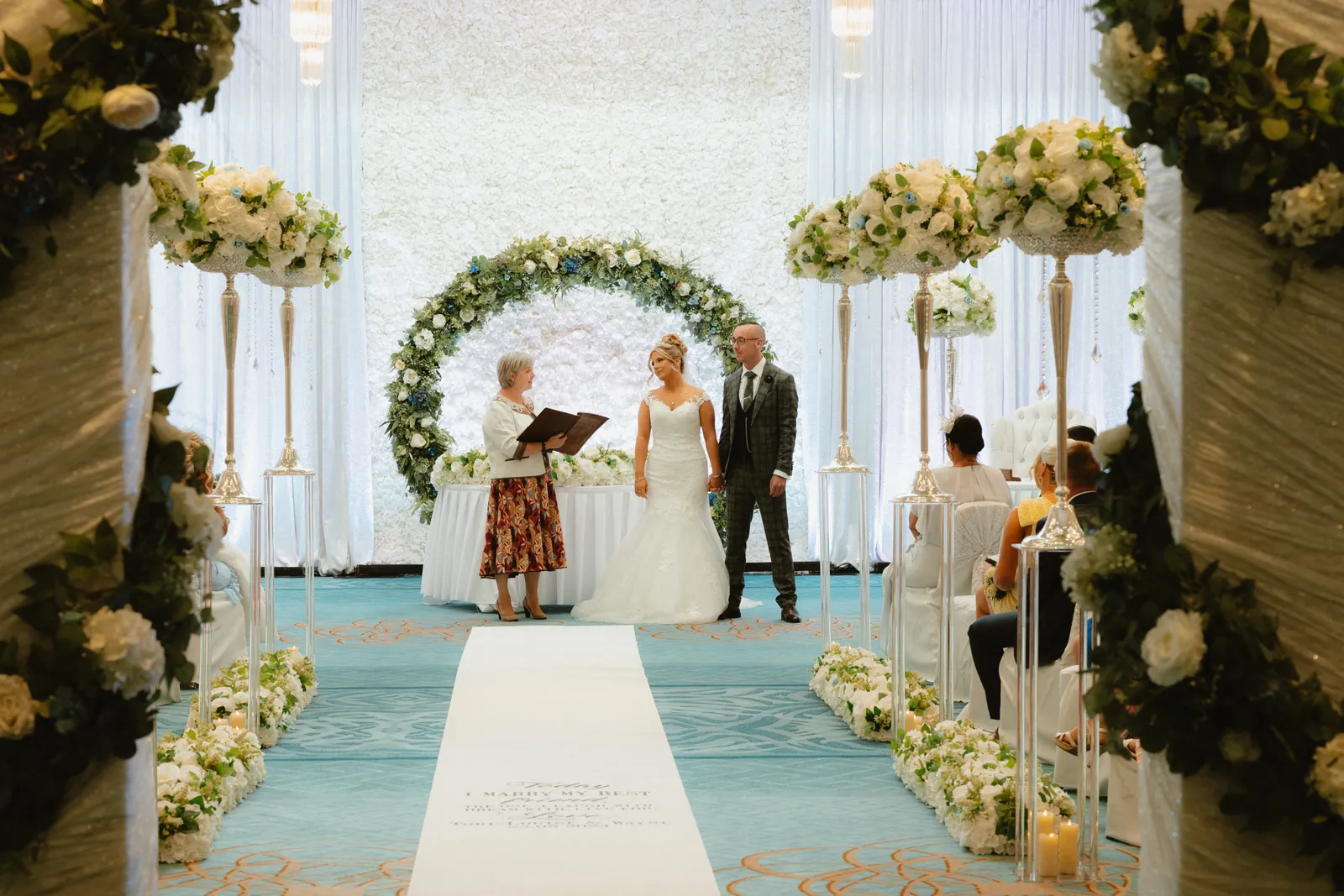 Wide view of the flower-lined ceremony aisle
