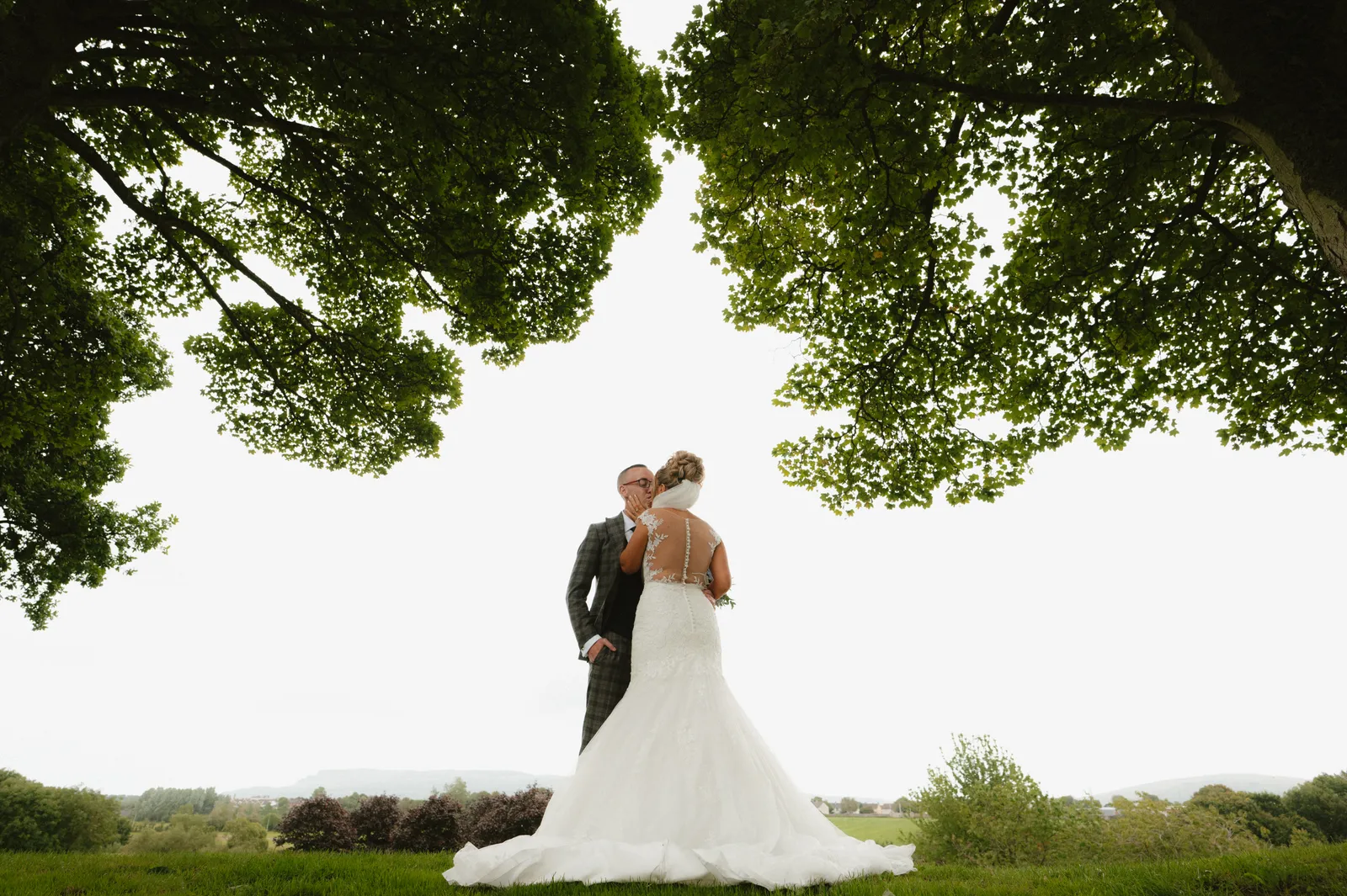 Tori and Wayne beneath a broad tree canopy at Roe Park Resort in 2024