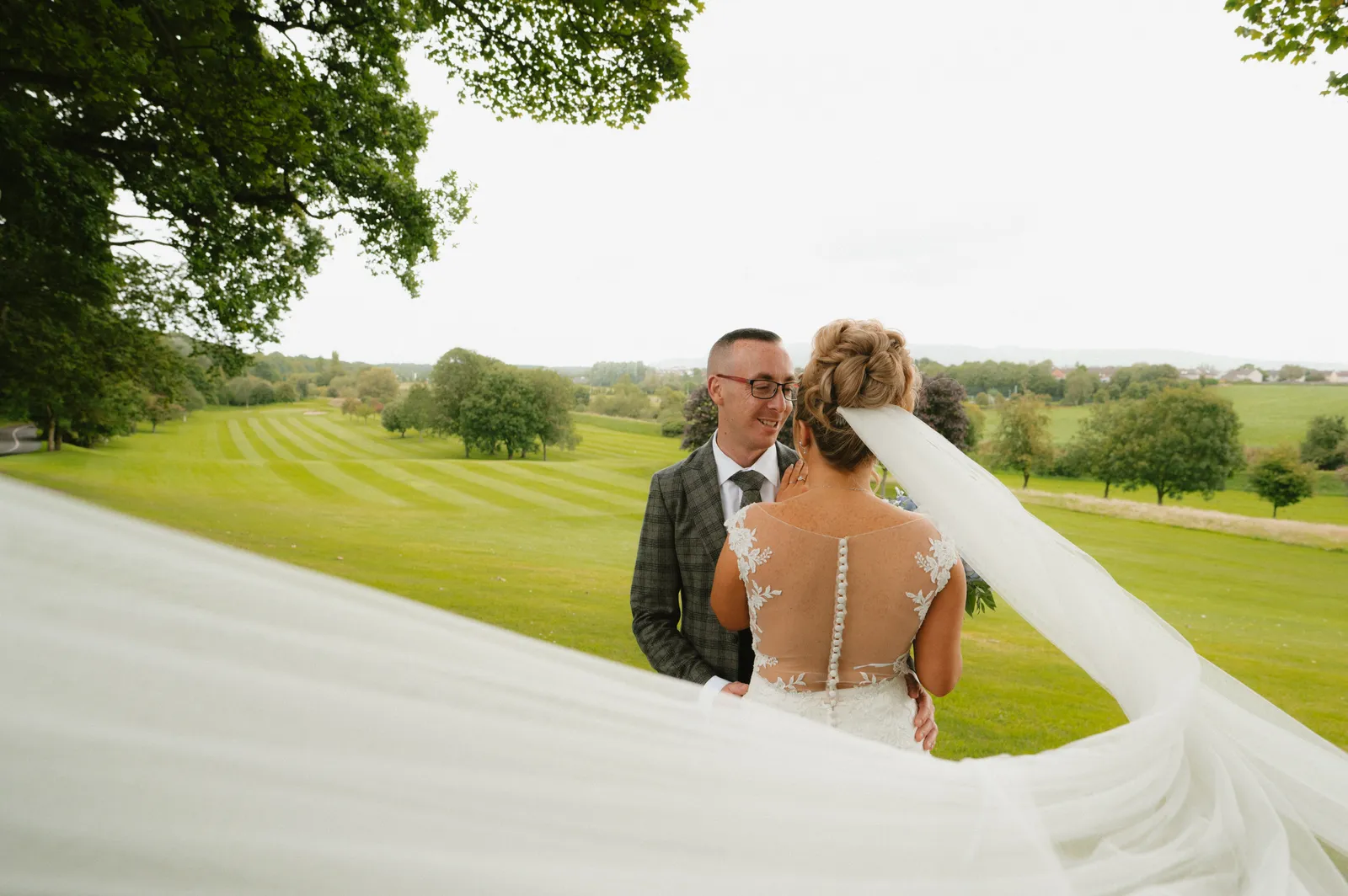 The veil stretches across the garden portrait