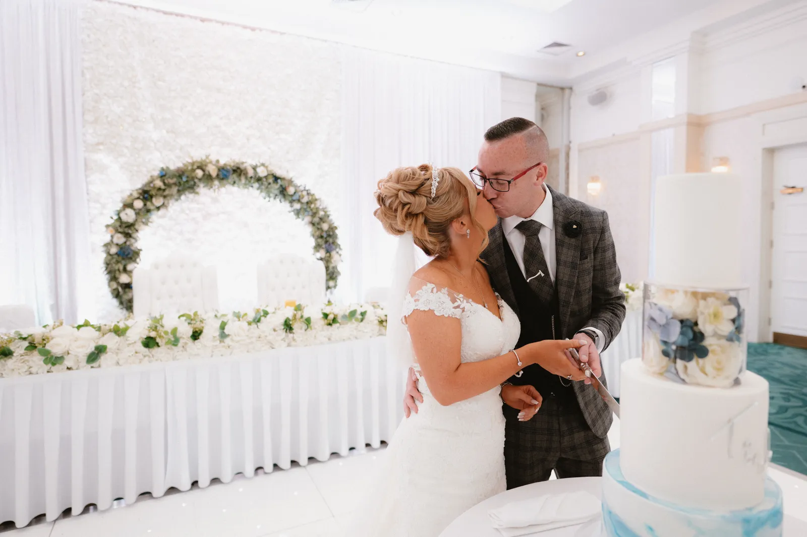 Tori and Wayne beside the wedding cake