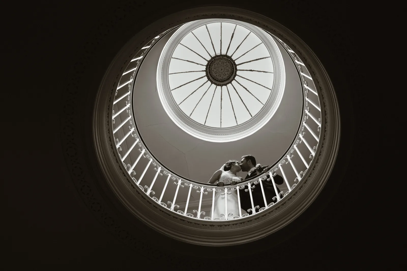 The couple beneath the circular stairwell