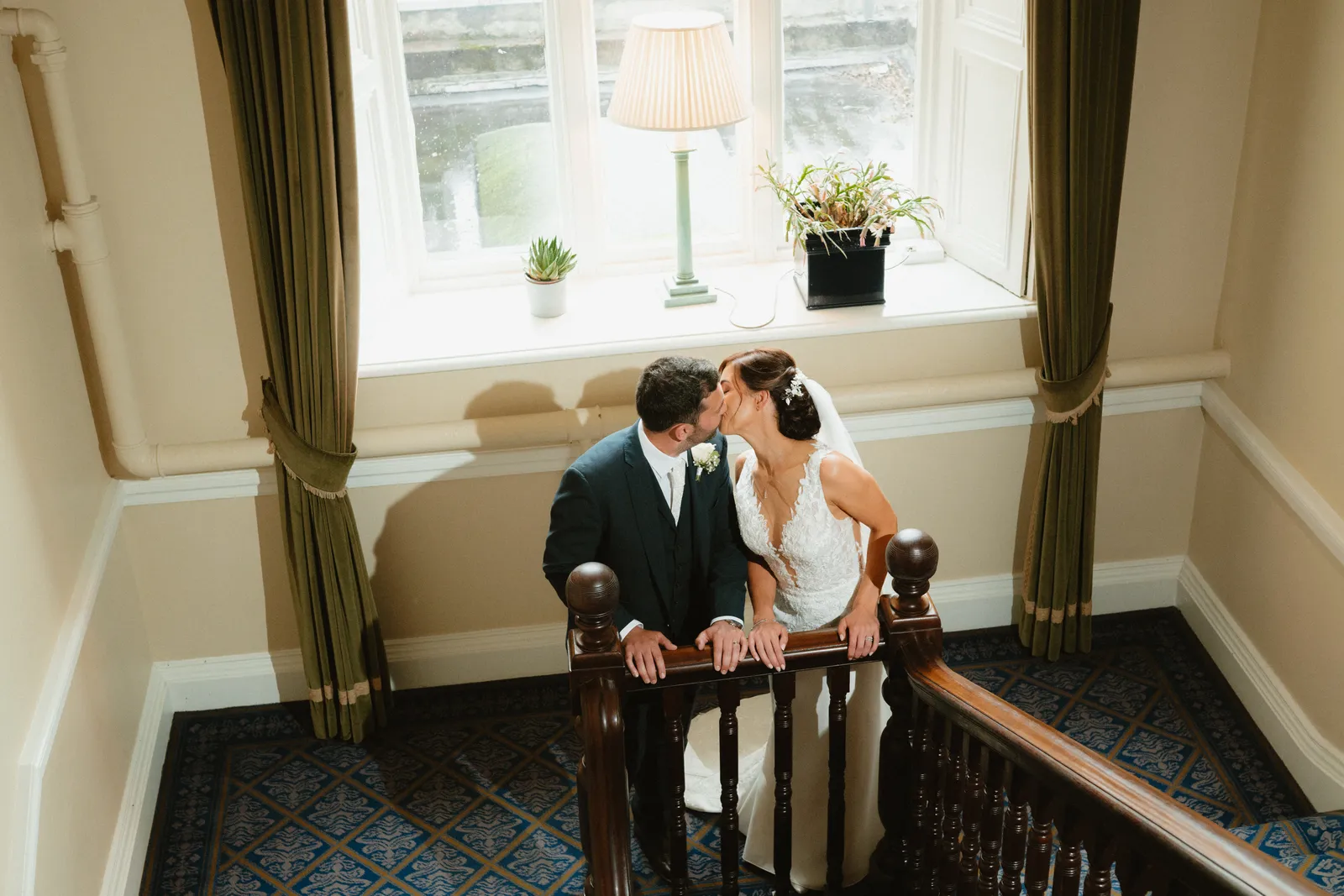 Vicky and Pairic sit together on the staircase landing at Ballymascanlon.