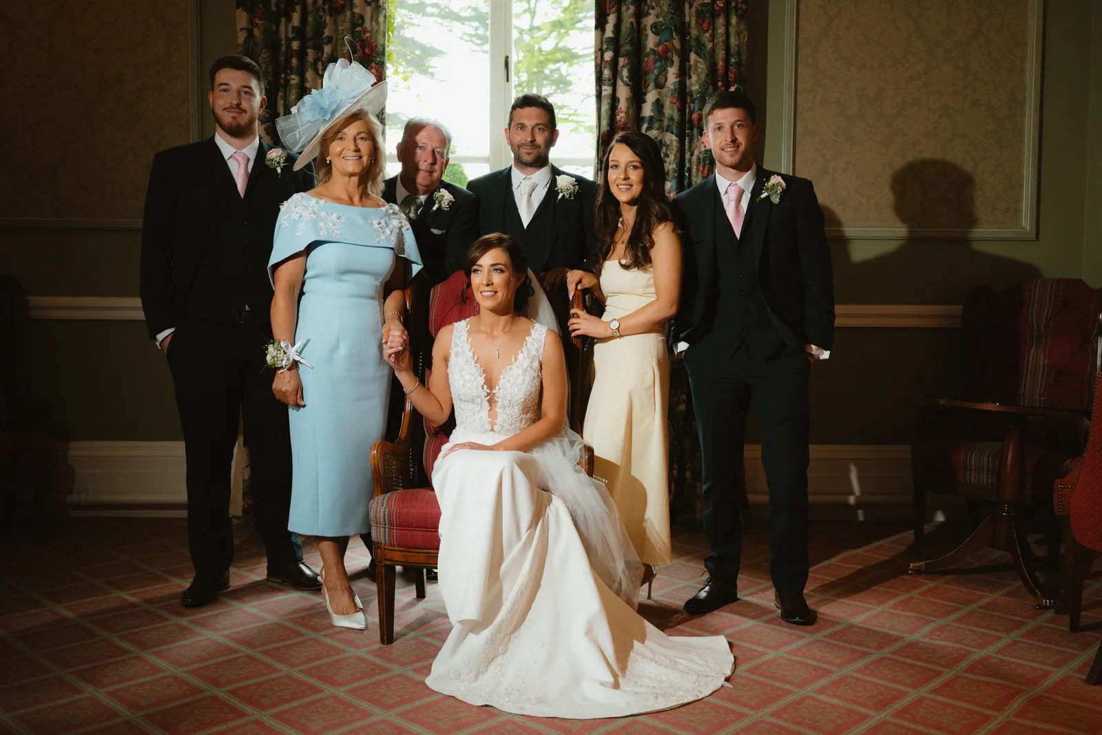 The couple with guests in a sitting room