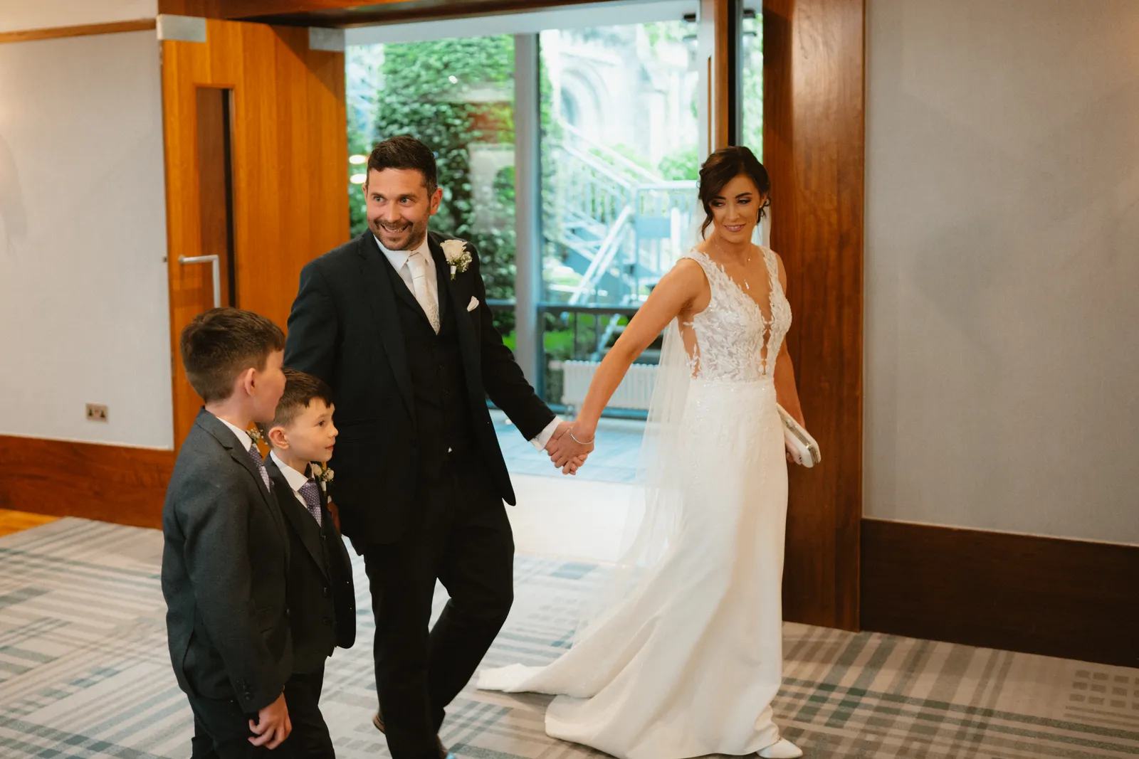The couple enter with a young guest