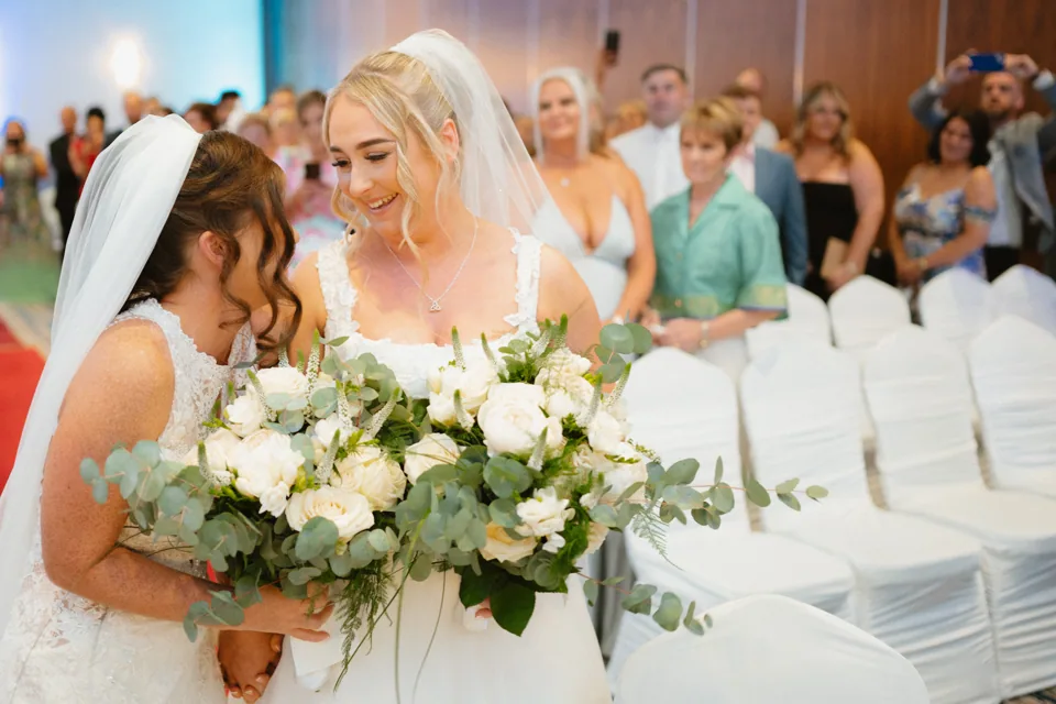 Zoe and Siobhra behind their bouquets