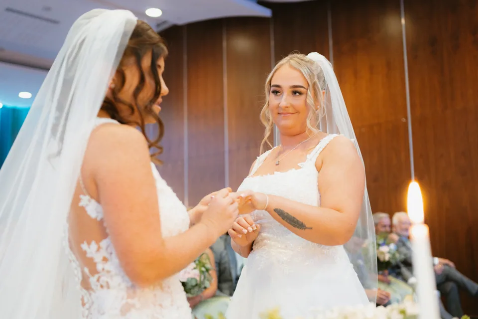 The couple holding hands during the ceremony