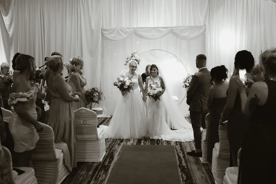 The couple walking back through their guests