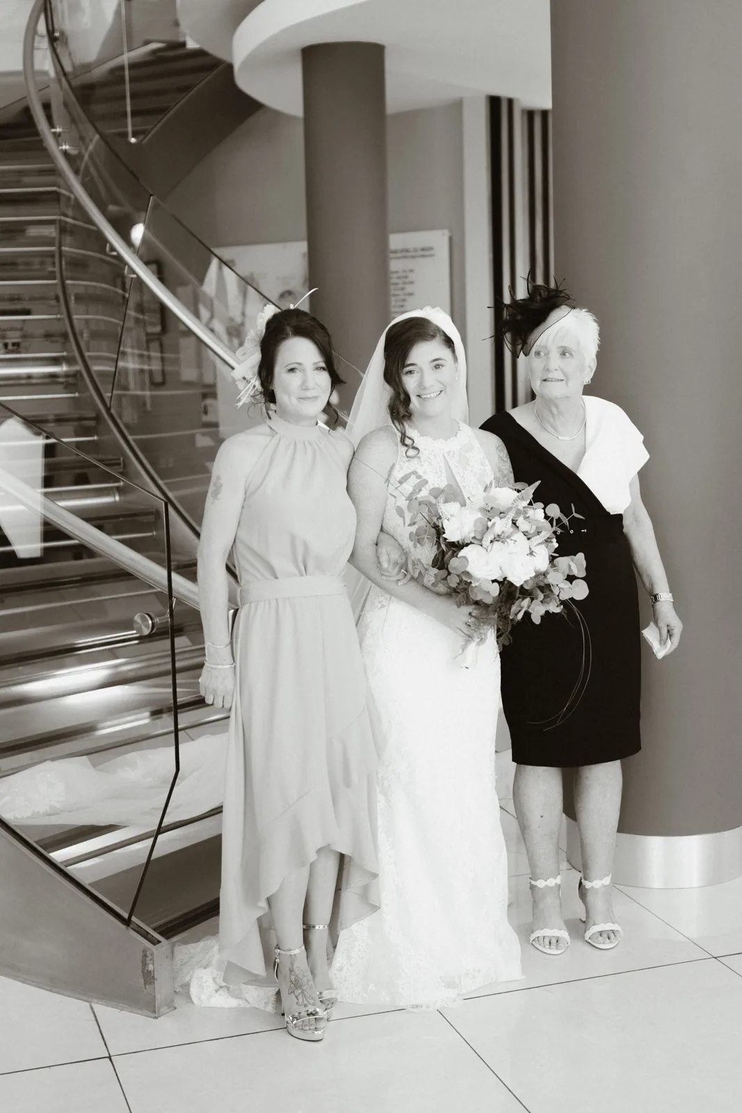 The wedding party beside the staircase
