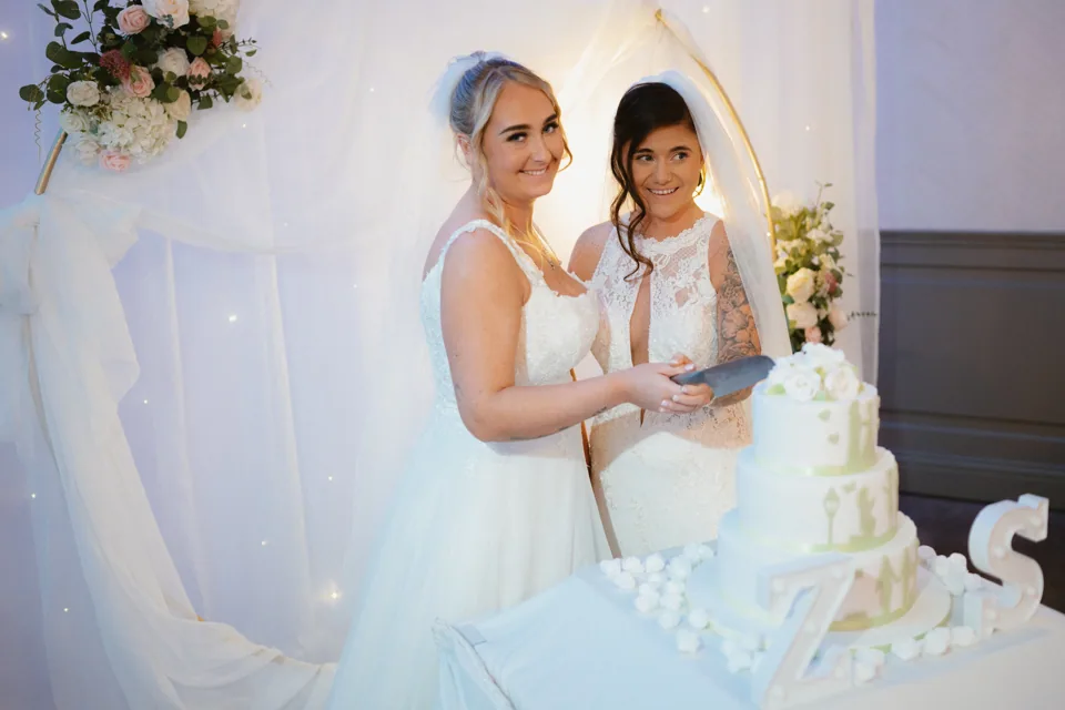 The couple beside the wedding cake